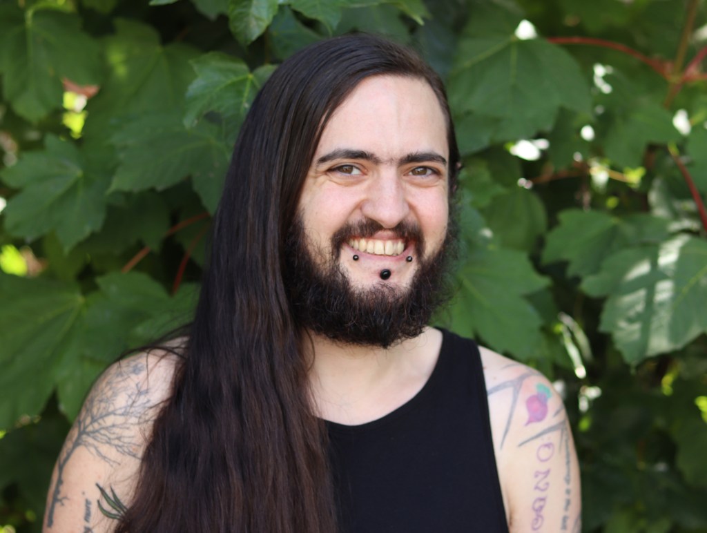 Maximillian is stood facing the camera smiling